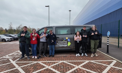 Creating Tomorrow College learners standing next to a brand-new minibus with Creating Tomorrow logo on the side